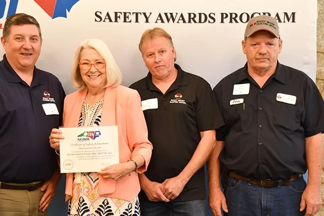 Rocky Mount Electric Motor accepting their certificate of safety achievement from NCDOL.