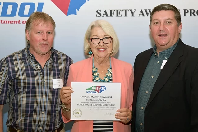 Rocky Mount Electric Motor accepting their certificate of safety achievement from NCDOL.