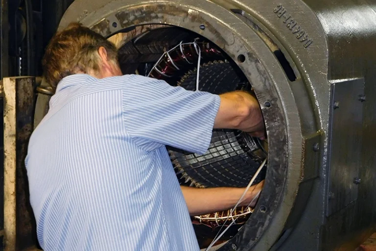 A member of Rocky Mount Electric Motor's technicians performing electric motor rewiring.