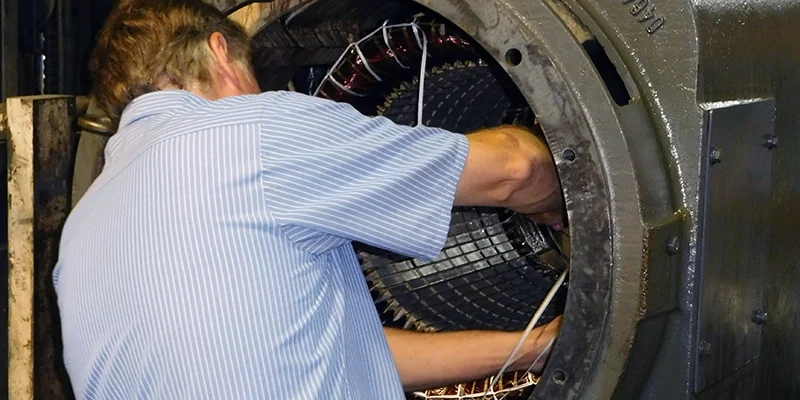 A member of Rocky Mount Electric Motor's technicians performing electric motor rewiring.