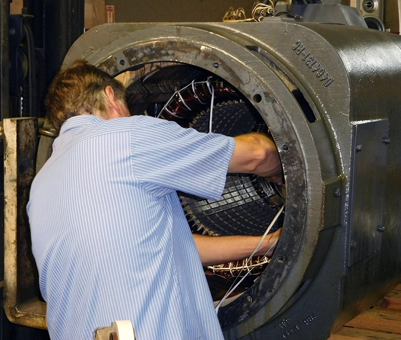 A member of Rocky Mount Electric Motor's technicians performing electric motor rewiring.