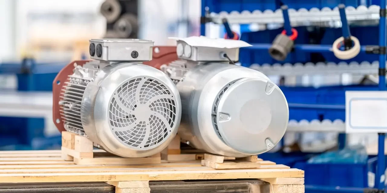 two_electric_motors_on_pallet_in_factory-min Two electric motors sit on a pallet in a production factory.