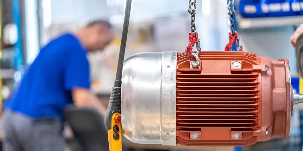 electric-motor-hung-on-the-production-line-in-the-2023-11-27-04-56-13-utc-min An electric motor hung on a production line in a workshop.