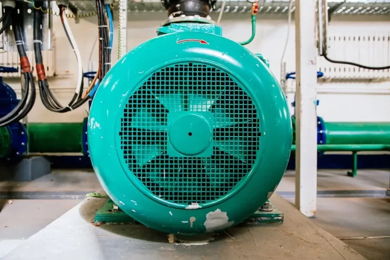 The front face of an industrial electric motor in a maintenance tunnel.