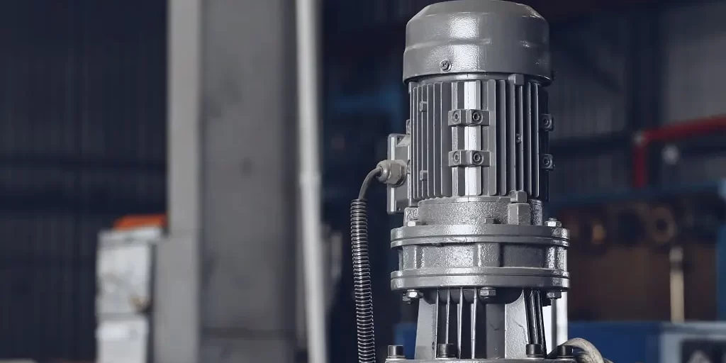 metal-production-equipment-at-the-cable-plant-2023-11-27-05-34-47-utc-min An electric motor standing vertically in a metal production in a cable plant.