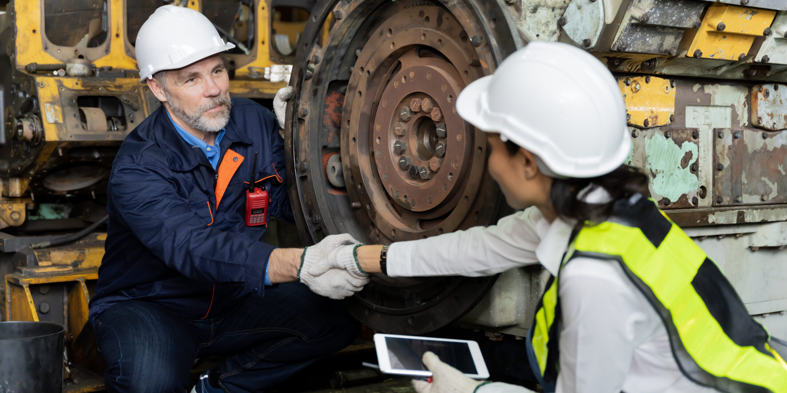 A business man inspects the work of an on-site worker A business man inspects the work of an on-site worker