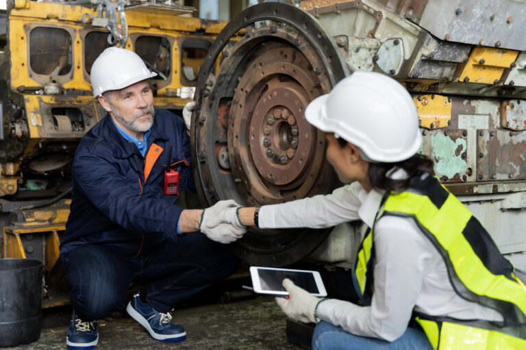 A business man inspects the work of an on-site worker
