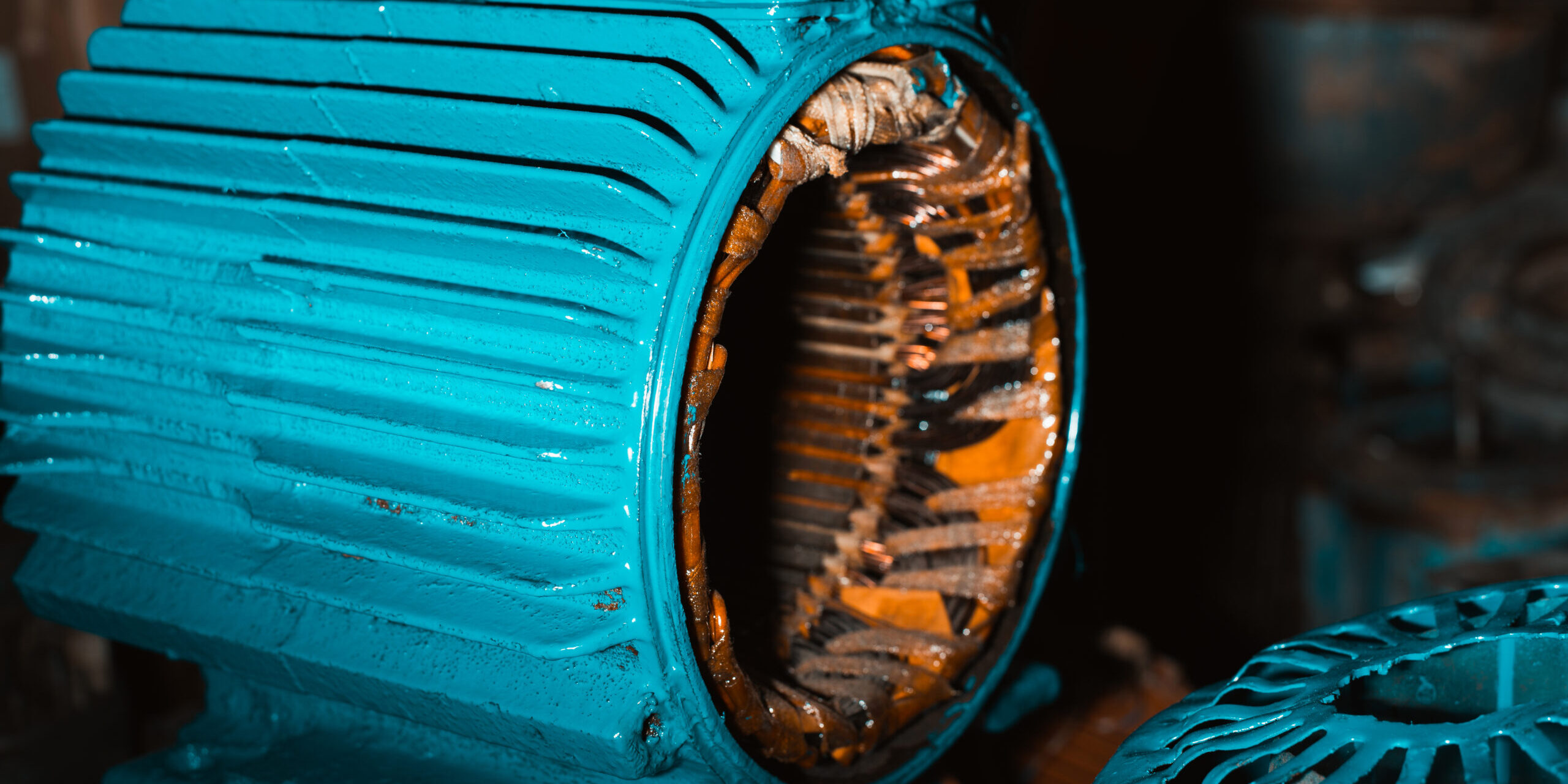 Broken disassembled electric motor, stator under repair in the garage. Industrial electrical equipment, technologies. Close-up, side view.